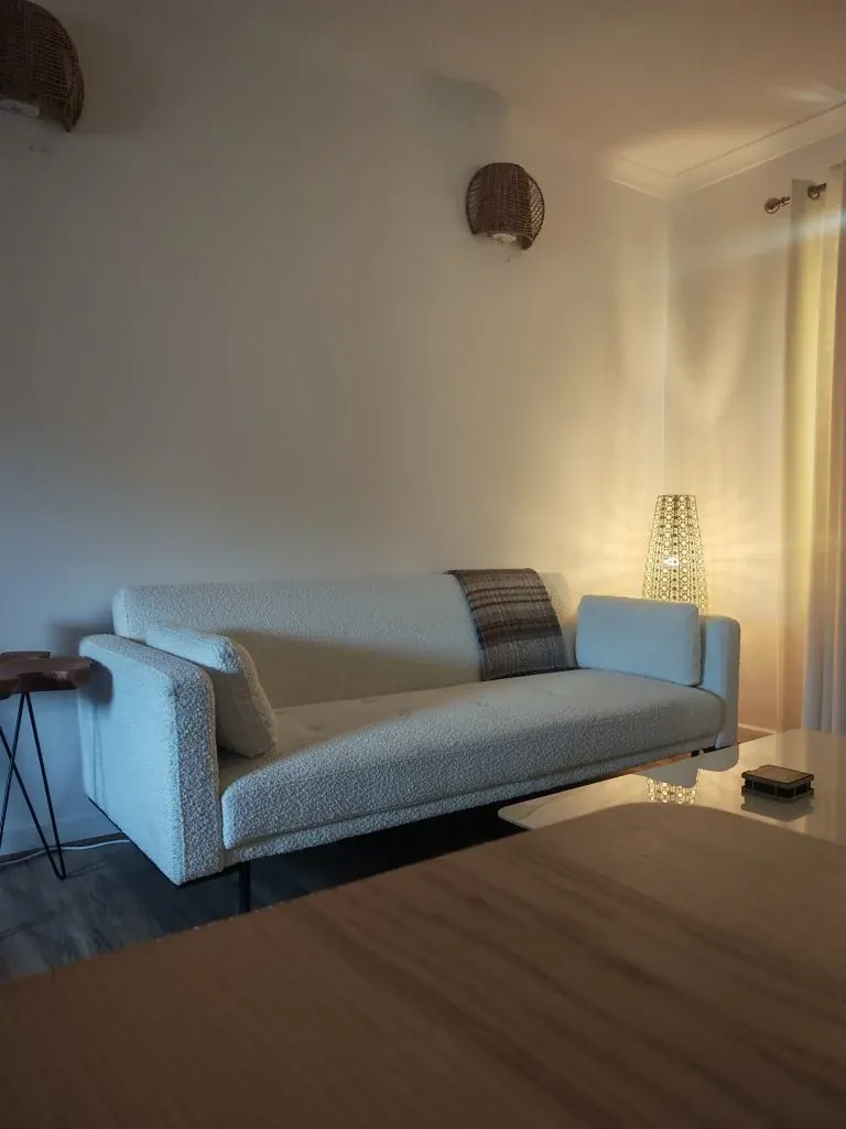 Blue sofa and wooden flooring in the living room at Dhuha Retreats
