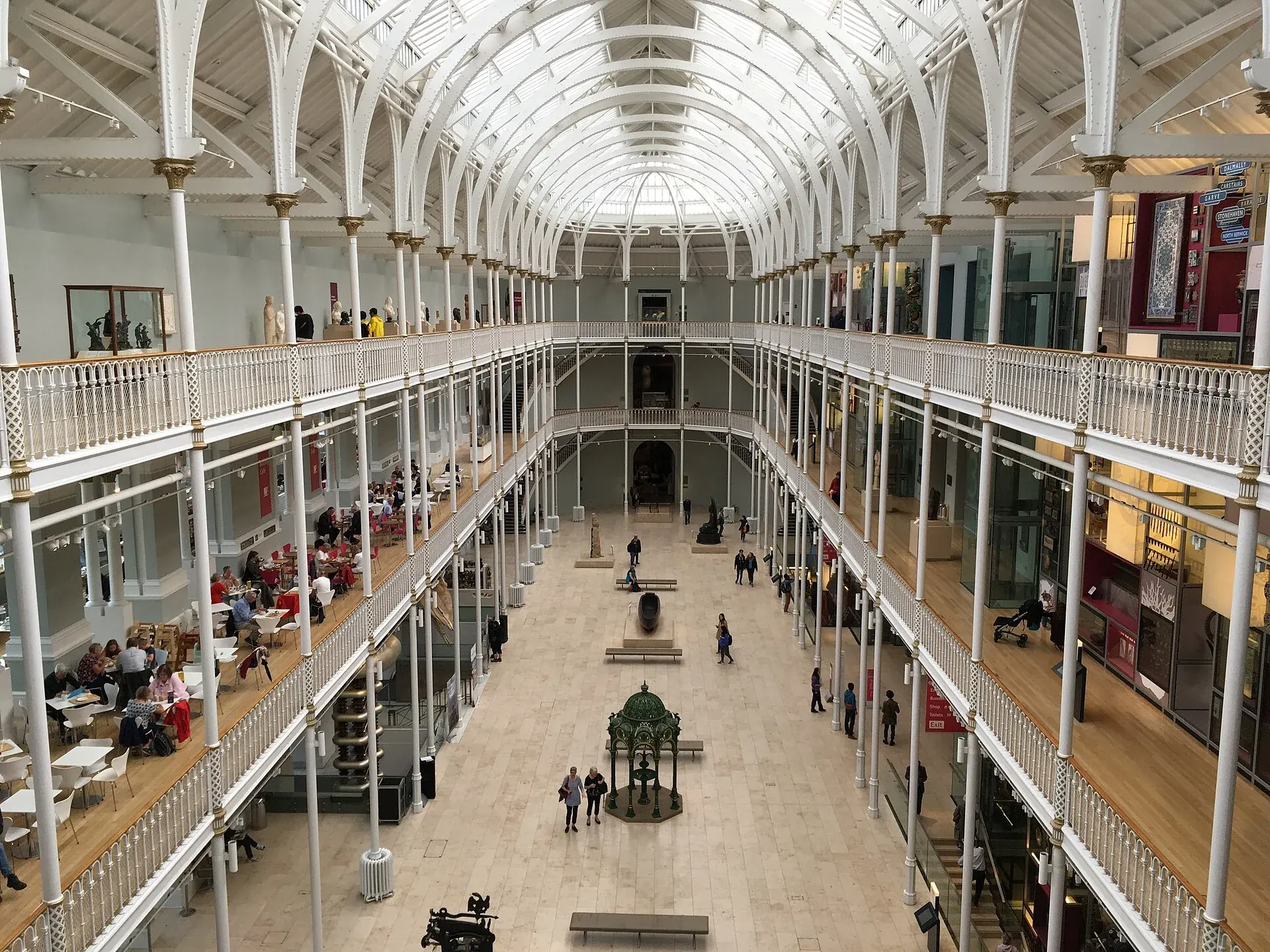 The bright Grand Gallery of the National Museum of Scotland, with white balconies and a glass roof